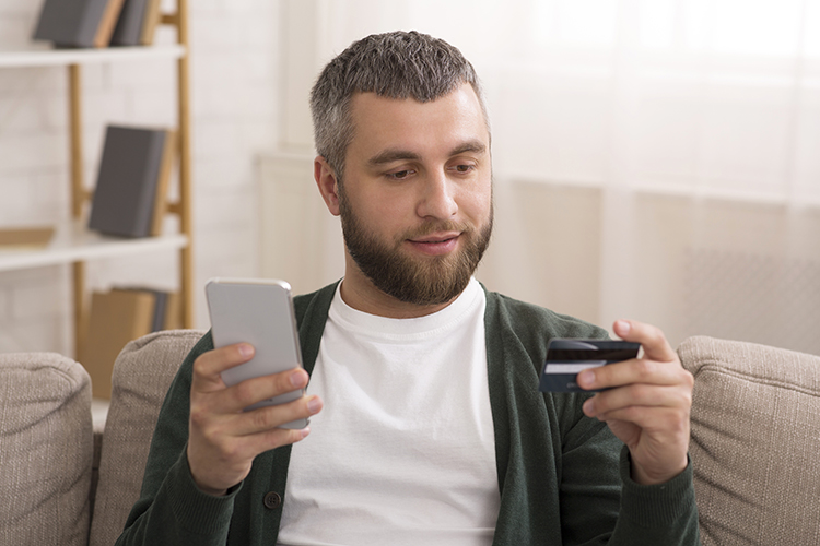 Man holding credit card, making online shopping with cellphone Bucks County, PA Website Design and SEO Company